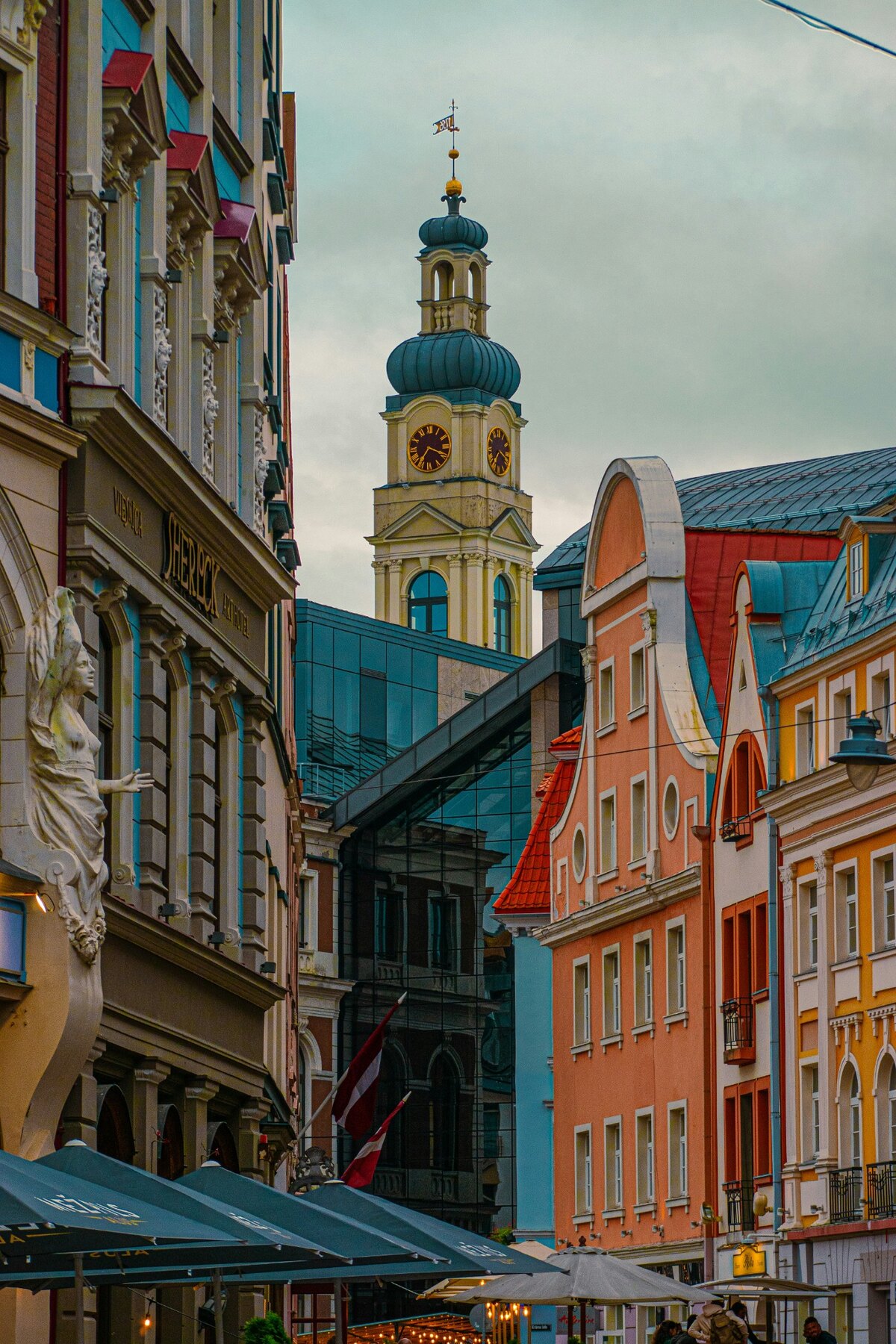 Colourful historic façades and café awnings on a Riga street