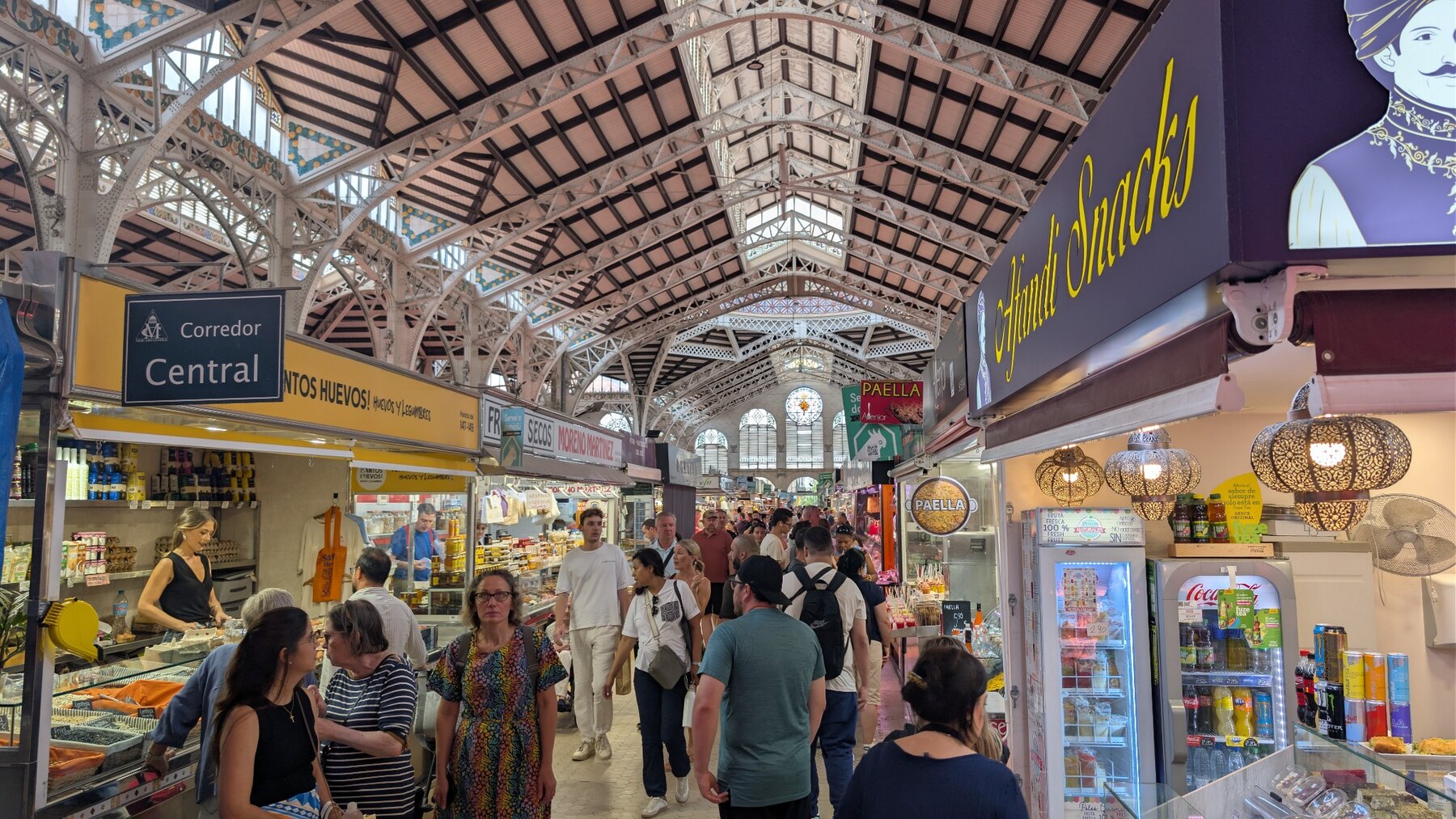 Shoppers beneath the iron roof of Valencia's Central Market