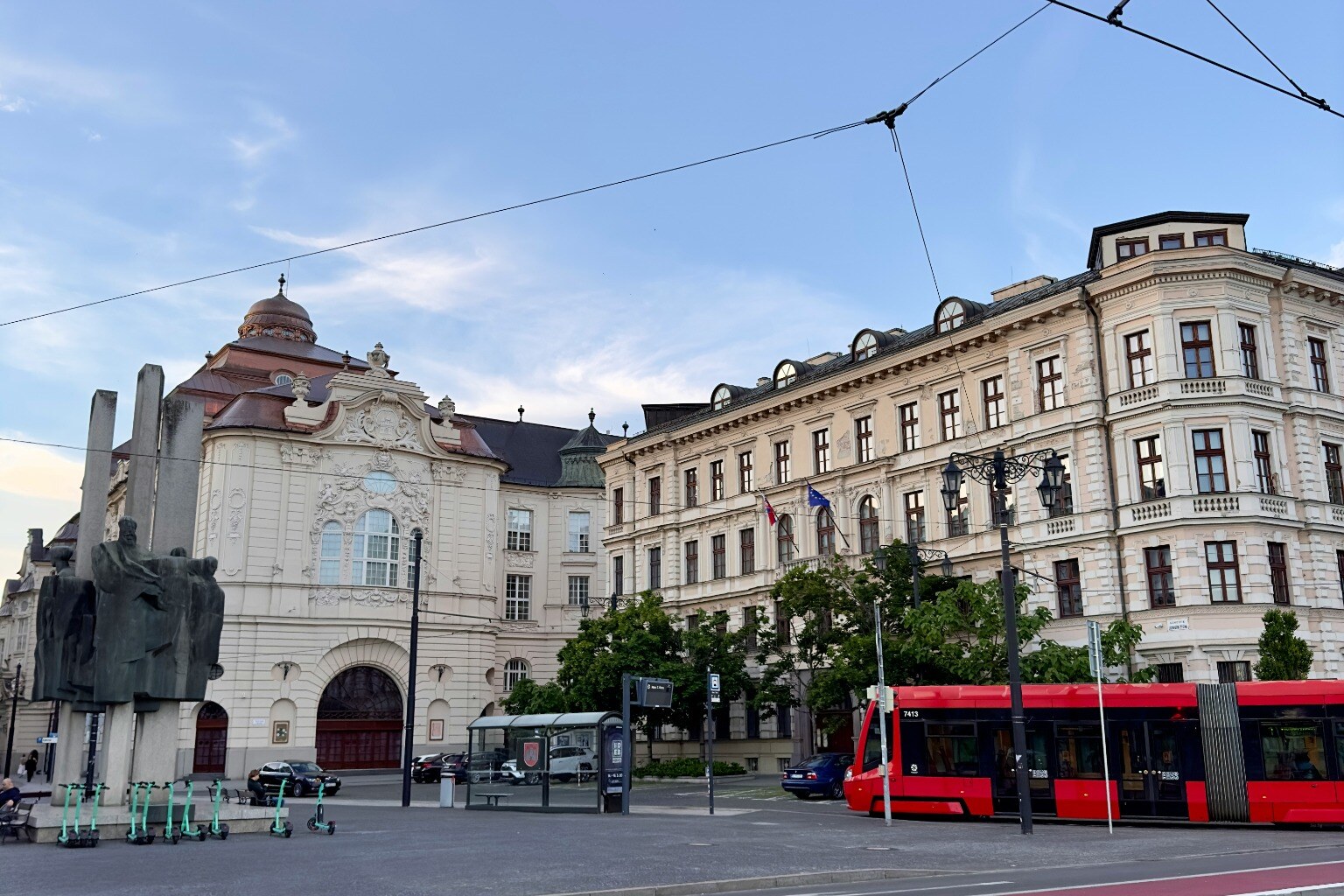 A red tram passing Bratislava's central historic architecture