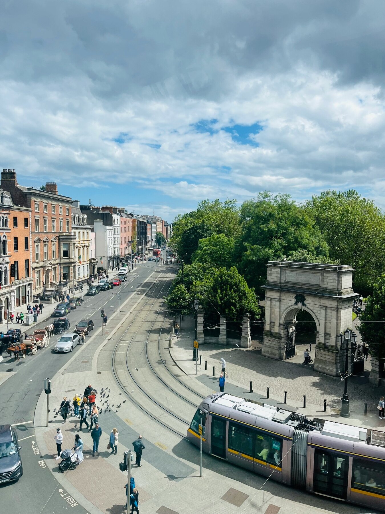 A tram passing St Stephen's Green and the Fusiliers' Arch in Dublin