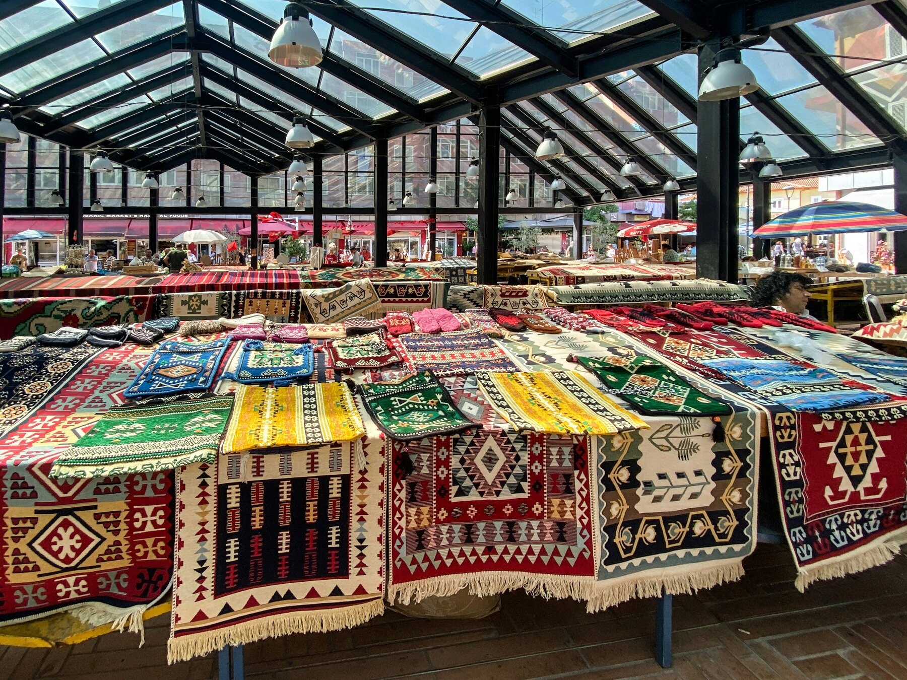 Colourful woven textiles displayed in Tirana's market
