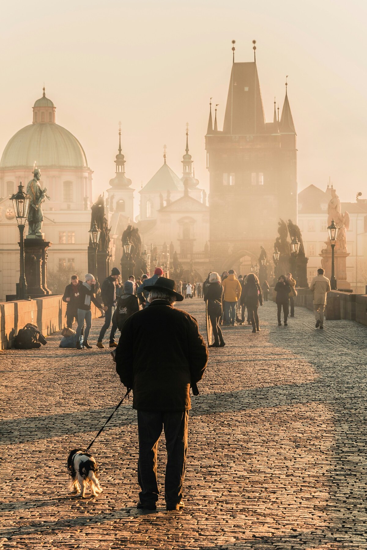 People walking through a lively square in central Prague