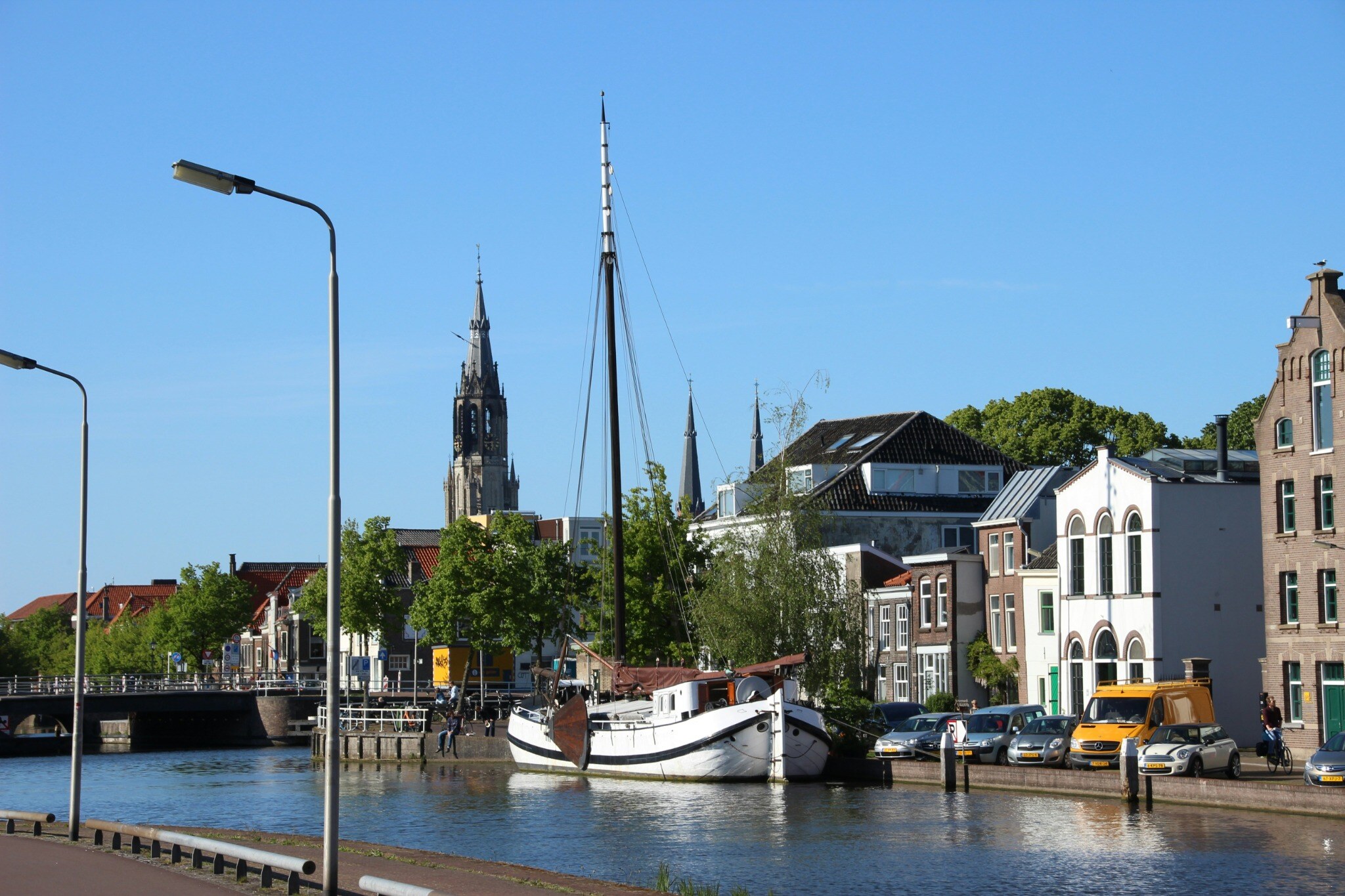 Delft's waterfront skyline with boats and the church tower