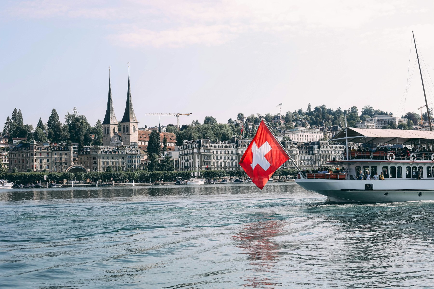 A passenger boat crossing Lake Lucerne beneath the mountains.