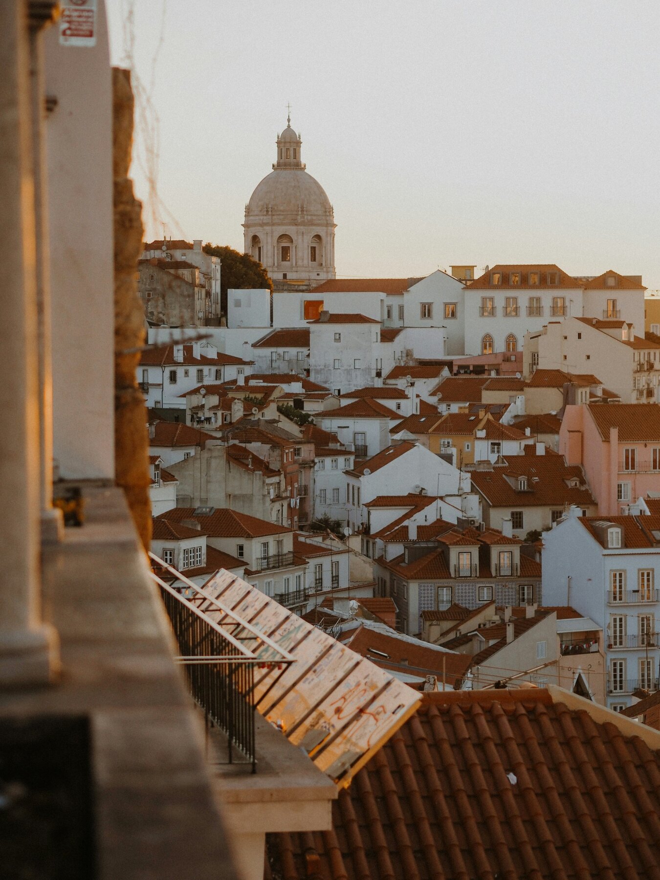 Warm evening view across Lisbon rooftops and church towers