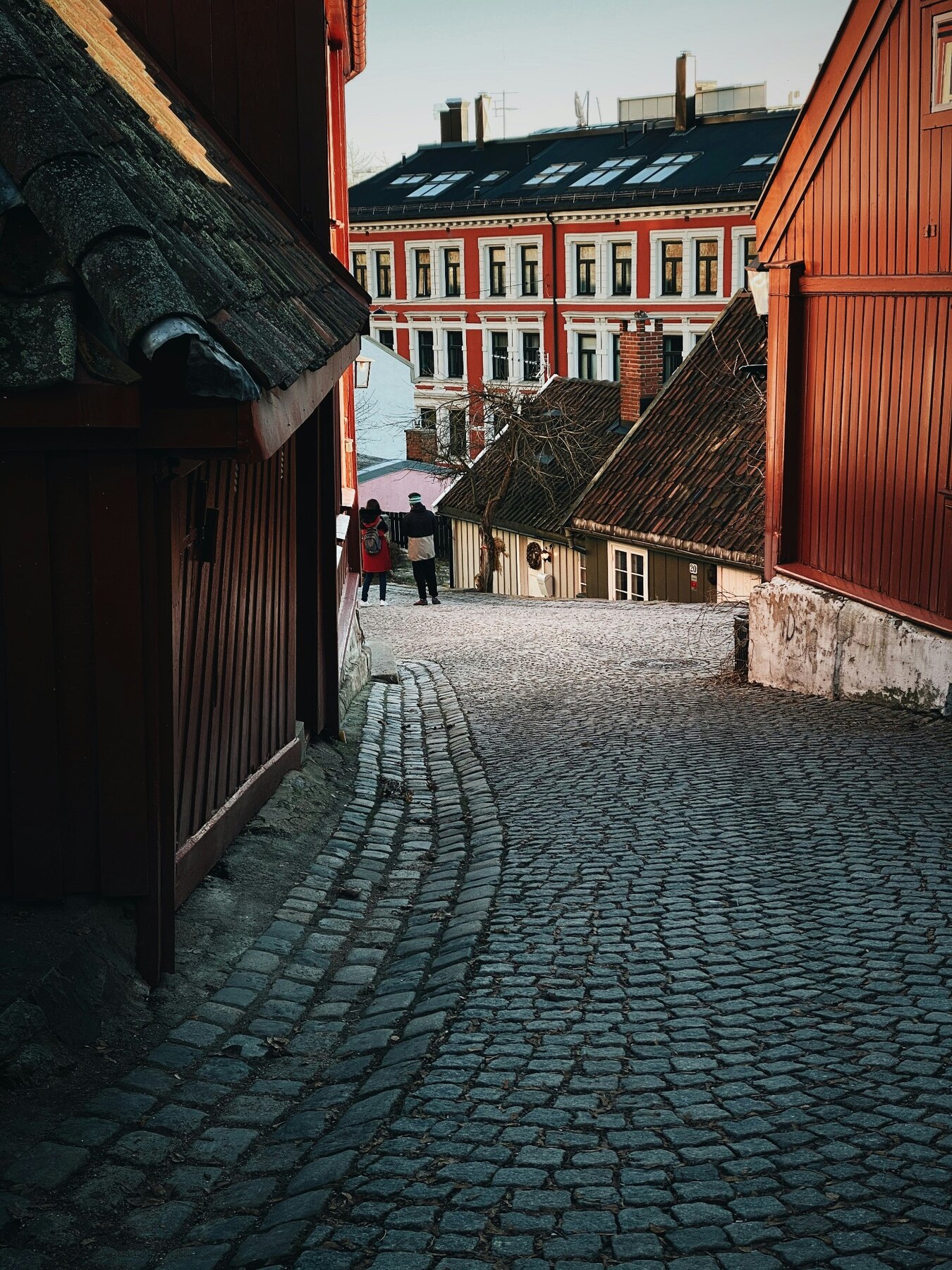 A quiet cobbled lane and timber buildings in Oslo