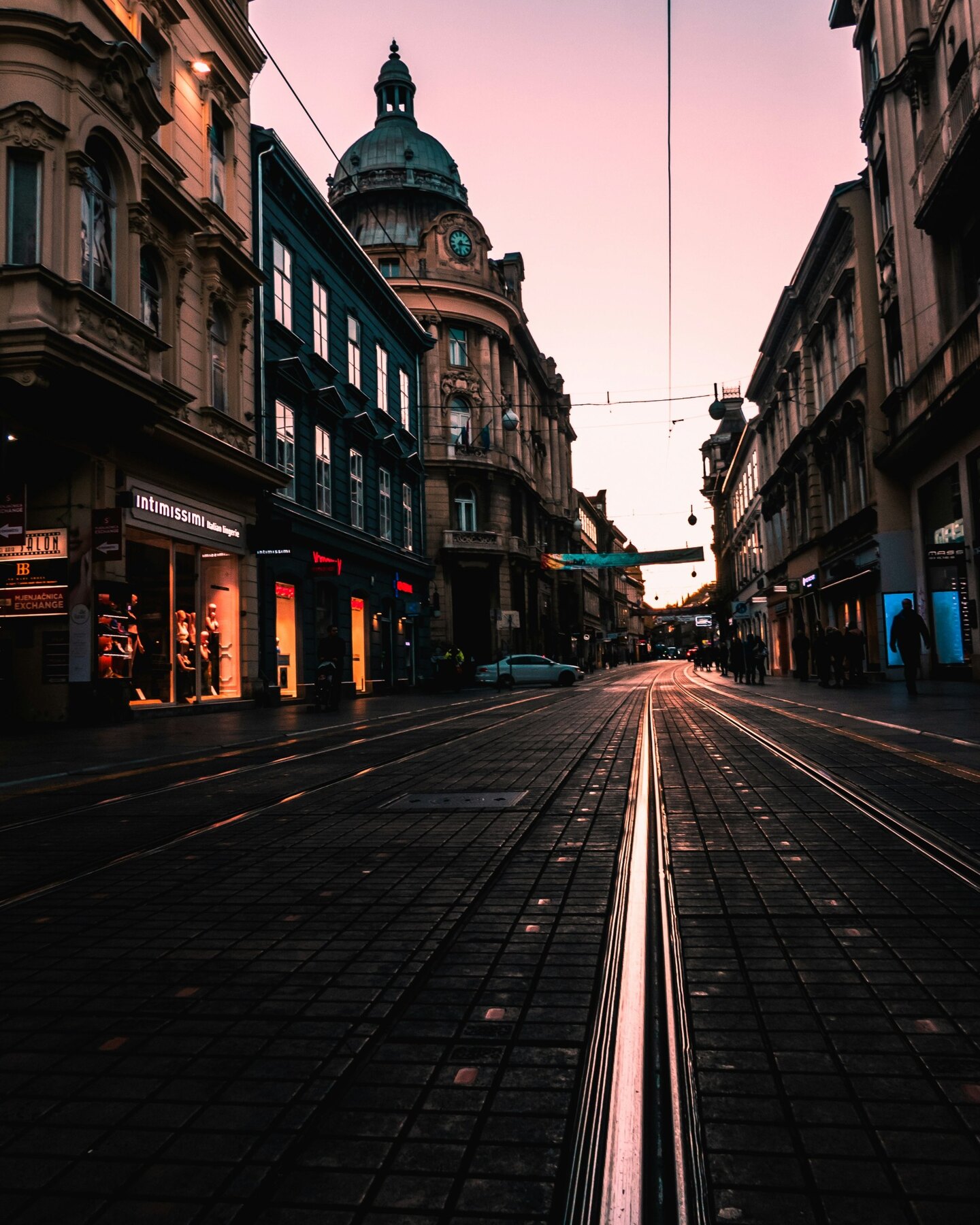 Tram tracks running along a city-centre street in Zagreb at dusk